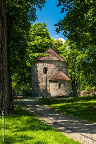 Vertical shot of a medieval rotunda at Castle Hill with an alley and trees around in Cieszyn, Poland photo