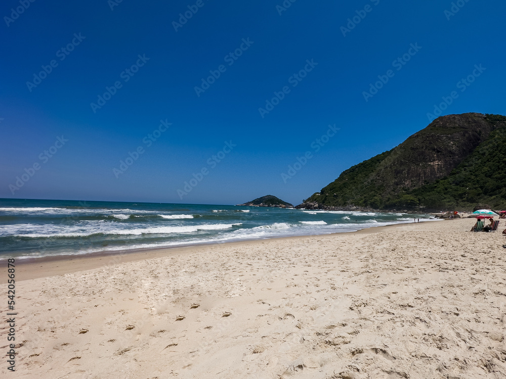 View of Prainha Beach, a paradise in the west side of Rio de Janeiro, Brazil. Big hills around. Sunny day
