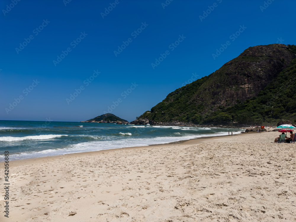 View of Prainha Beach, a paradise in the west side of Rio de Janeiro, Brazil. Big hills around. Sunny day