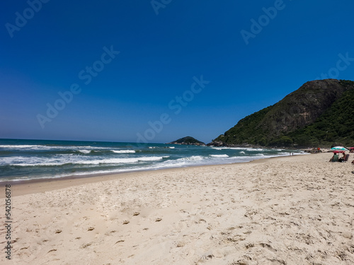 View of Prainha Beach, a paradise in the west side of Rio de Janeiro, Brazil. Big hills around. Sunny day