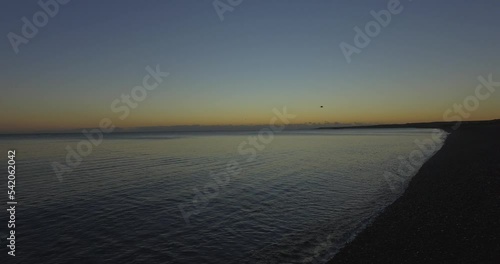 calm sunrise in the patagonic sea (sunken ship) photo