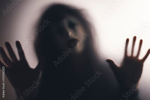 Shadowy figure behind glass - horror background