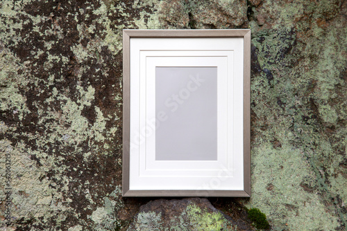 Picture frame on rock background. Empty frame with copy space passe partout, natural background, art information, sign concept photo