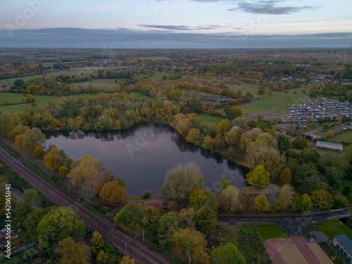 An aerial view of the lake at sunrise in Needham Market, Suffolk UK