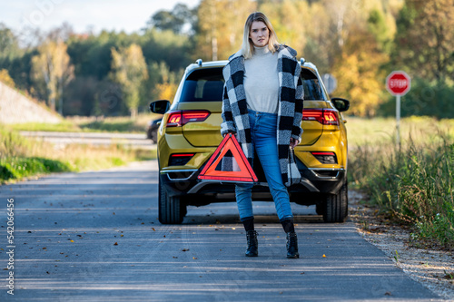 A woman waiting for roadside assistance.