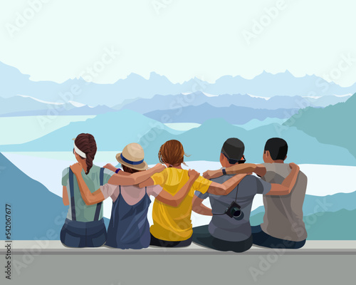 A group of young girls and guys against the backdrop of beautiful mountains sit and hug each other, they are friends. Free and happy people, the concept of friendship between men and women. 