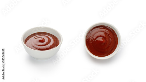 Red ketchup or tomato sauce in a white little bowl, gravy boat isolated on white background with clipping path, cut out.