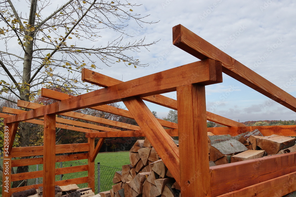 The construction of the roof. The connection of the rafter beam. Construction of a shed for wood. The construction of the roof. The connection of the rafter beam. Construction of a shed for wood.