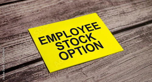 Employee Stock Option word on yellow sticker and wooden background