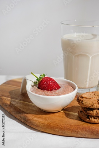 Vertical shot of strawberry dessert with milk and cookies