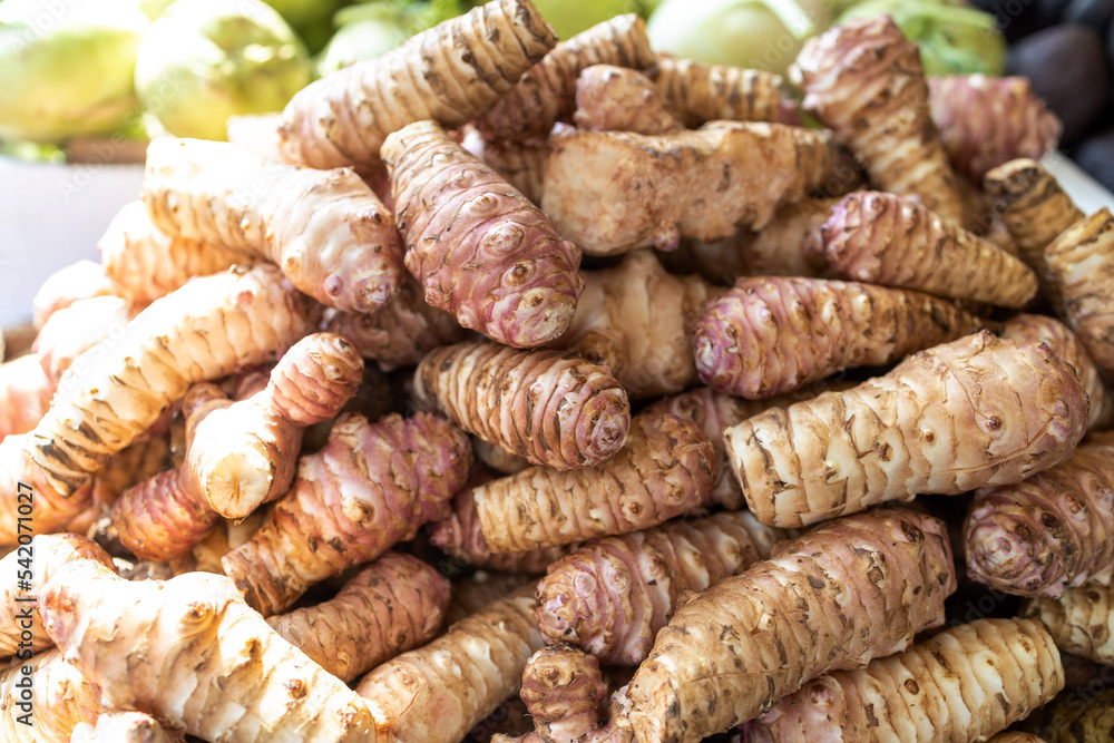 Fresh pink Jerusalem artichoke in the box for sale in the market Fresh pink Jerusalem artichoke in the box for sale in the market