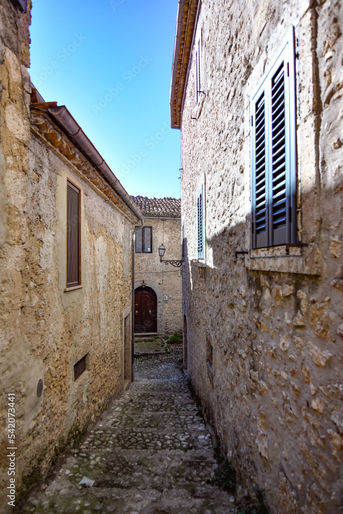 A narrow street between the old stone houses of Civitavecchia di Arpino, a medieval village in the Lazio region, Italy.