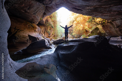 Adventurous woman standing inside a cave. Adventure Travel. Little Huson Caves Park, Vancouver Island, British Columbia, Canada.