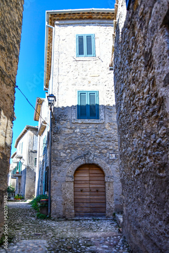 A narrow street between the old stone houses of Civitavecchia di Arpino, a medieval village in the Lazio region, Italy.