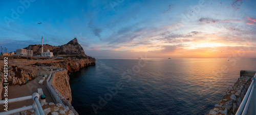 Europa Point Lighthouse with sea in background. Colorful Cloudy Sunrise Sky. Gibraltar, United Kingdom. Panorama