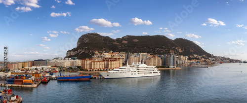 City Buildings, Port and Mountain by the Sea. Cloudy Sky Art Render. Gibraltar, United Kingdom. Panorama