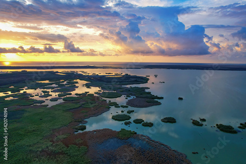 Awesome view of small islets formed in wetland in Göksu delta at sunrise, magnificent sunrise view, clouds, sea and small islets © yakupyener