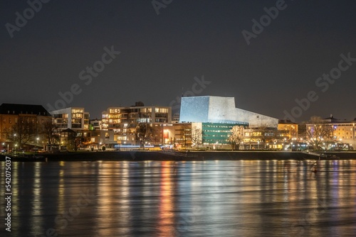 Theater Bonn Opera House near the Rhine River at night © Frank Landsberg/Wirestock Creators