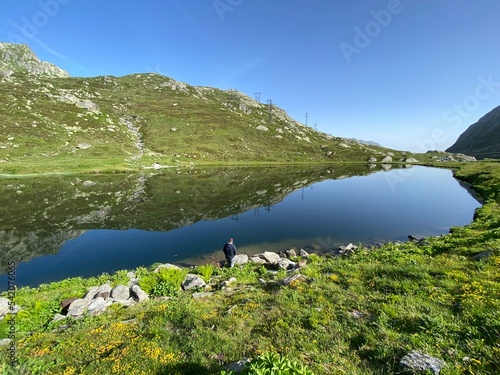 Summer atmosphere on the Lago di Rodont lake (Lake Rodont) in the Swiss alpine area of the mountain St. Gotthard Pass (Gotthardpass), Airolo - Canton of Ticino (Tessin), Switzerland (Schweiz) photo
