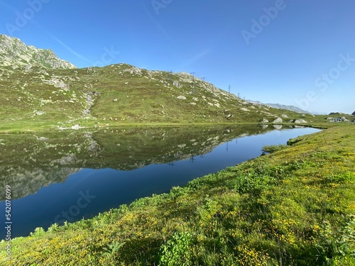 Summer atmosphere on the Lago di Rodont lake (Lake Rodont) in the Swiss alpine area of the mountain St. Gotthard Pass (Gotthardpass), Airolo - Canton of Ticino (Tessin), Switzerland (Schweiz) photo