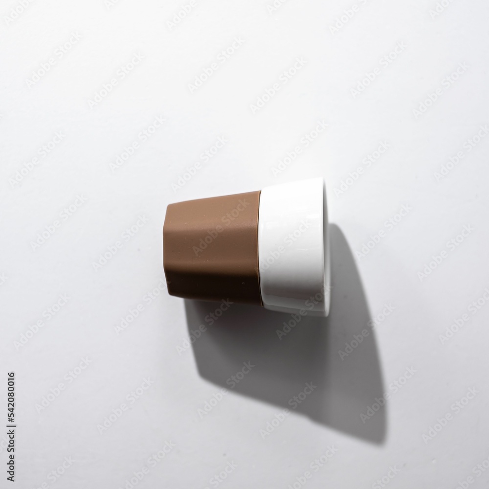 Top view of a white and brown ceramic cup on a white surface Top view of a white and brown ceramic cup on a white surface