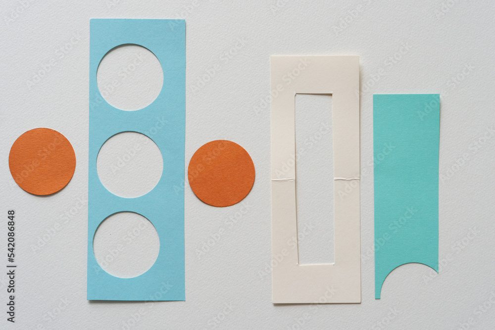 orange paper discs and paper shapes on blank paper orange paper discs and paper shapes on blank paper