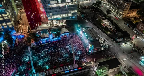 Aerial view of a crowd enjoying in a live Music Festival at night, timelapse video 