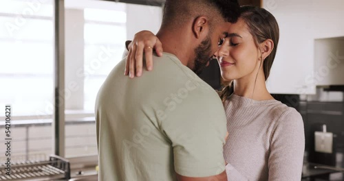 Love, couple and dance in kitchen, happy and smile while embrace, bond and relax together. Music, romance and dancing by interracial man with woman, flirt and intimate relationship moment in home