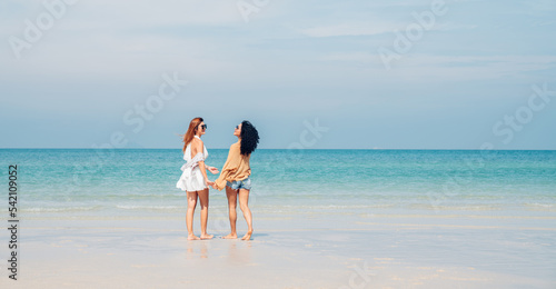 Happy beauty woman walking and dancing together on the beach having fun in a sunny day, Beach summer holiday sea people concept.