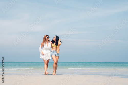 Happy beauty woman walking and dancing together on the beach having fun in a sunny day  Beach summer holiday sea people concept.