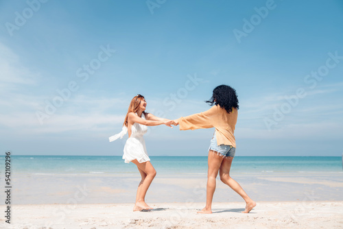 Happy beauty woman walking and dancing together on the beach having fun in a sunny day  Beach summer holiday sea people concept.
