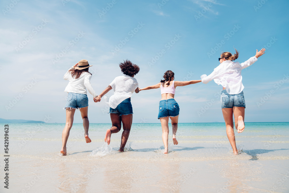 Happy friends at beach party runs together on the beach having fun in a sunny day, Beach summer holiday sea people concept