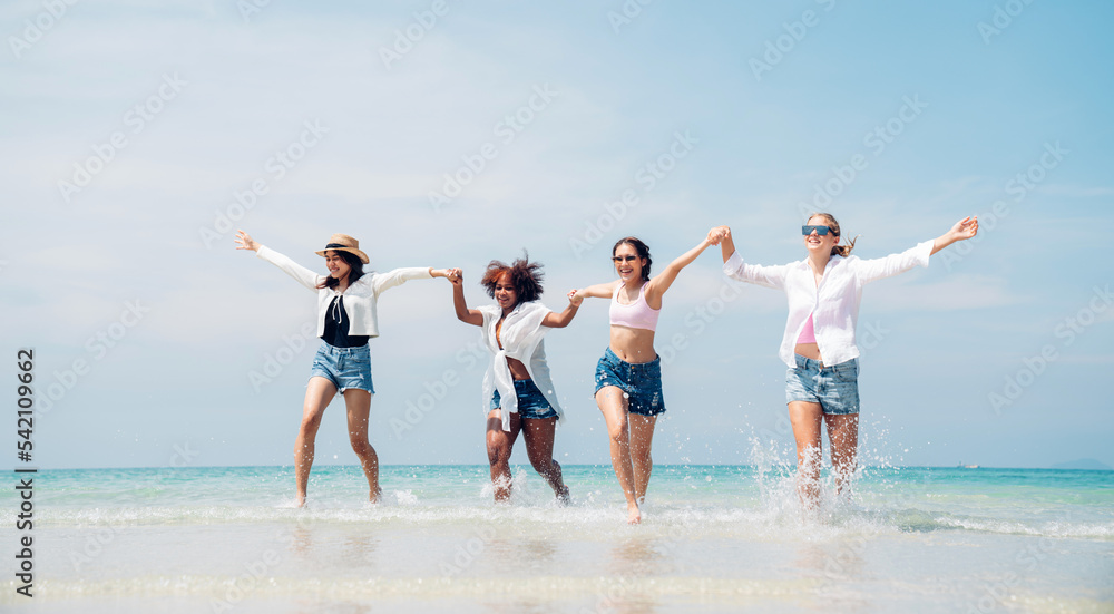 Happy friends at beach party runs together on the beach having fun in a sunny day, Beach summer holiday sea people concept