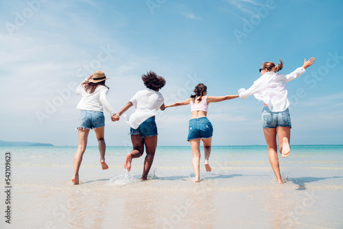 Happy friends at beach party runs together on the beach having fun in a sunny day, Beach summer holiday sea people concept