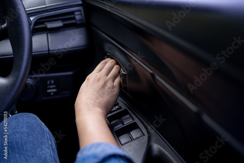 Woman's hand pushing a button to open a car door
