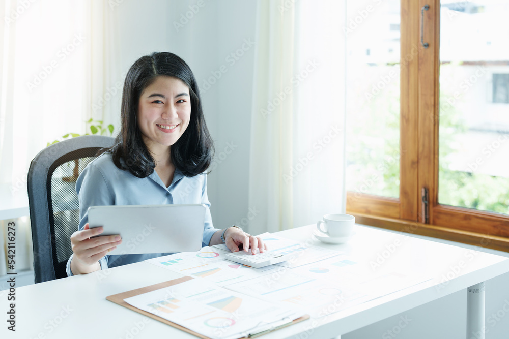financial, Planning, Marketing and Accounting, portrait of Asian employee checking financial statements using documents and calculators at work financial, Planning, Marketing and Accounting, portrait of Asian employee checking financial statements using documents and calculators at work