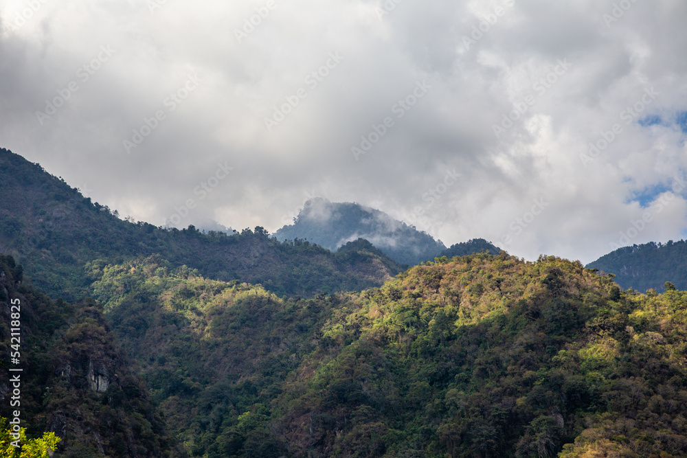 Low clouds brush against forest mountains near Lake Atitlan, Guatemala.