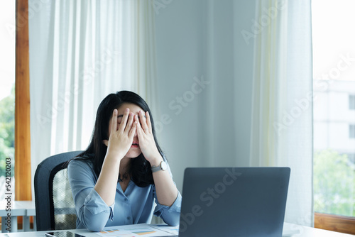 Portrait of sme business owner, woman using computer and financial statements Anxious expression on expanding the market to increase the ability to invest in business
