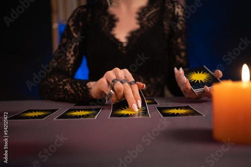A fortune teller reading Tarot cards. Hands close up. divination, astrology and esotericism photo