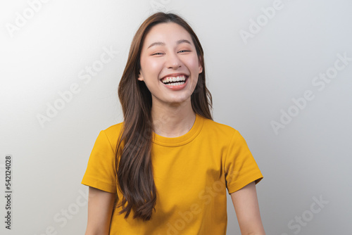 Photography Smiling positive, pretty asian young woman laugh, girl wearing yellow casual, portrait of beautiful brunette her with long hair, feeling happy looking at camera standing isolated on white background