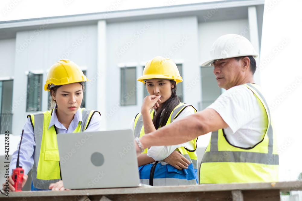 Engineers on building site. Engineer are working contruction on site plans to build high-rise buildings building. Architect caucasian man working with colleagues mixed race in the construction site. Engineers on building site. Engineer are working contruction on site plans to build high-rise buildings building. Architect caucasian man working with colleagues mixed race in the construction site.