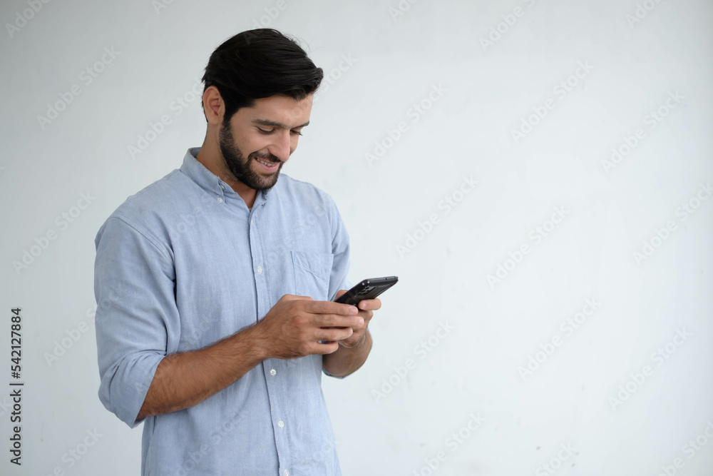 Happy engineering using mobile phone. caucasian man with smart phone. Young businessman on the way to the office searching information on the internet with smartphone. Business, lifestyle concept. Happy engineering using mobile phone. caucasian man with smart phone. Young businessman on the way to the office searching information on the internet with smartphone. Business, lifestyle concept.