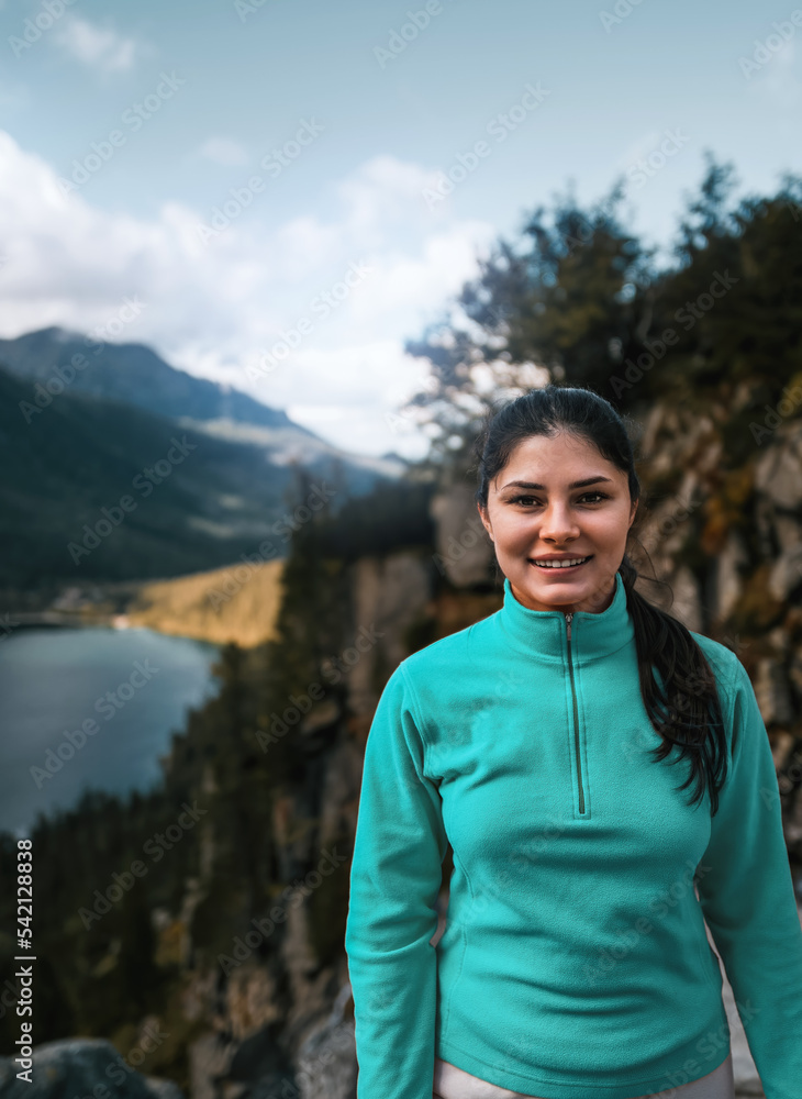 Happy girl in the mountains. Concept of hiking physical activities making you healthier and happier. Active way of life outdoors concept. Happy girl in the mountains. Concept of hiking physical activities making you healthier and happier. Active way of life outdoors concept.