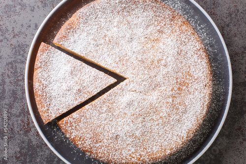 piece of traditional Greek yogurt cake Yaourtopita closeup in a plate on a table. Horizontal top view from above photo