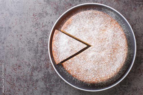 Yaourtopita Yogurt Cake delicious traditional Greek dessert closeup in a plate on a table. Horizontal top view from above photo