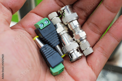 Set of CCTV connectors and BNC connectors in male hands. equipment for surveillance.
