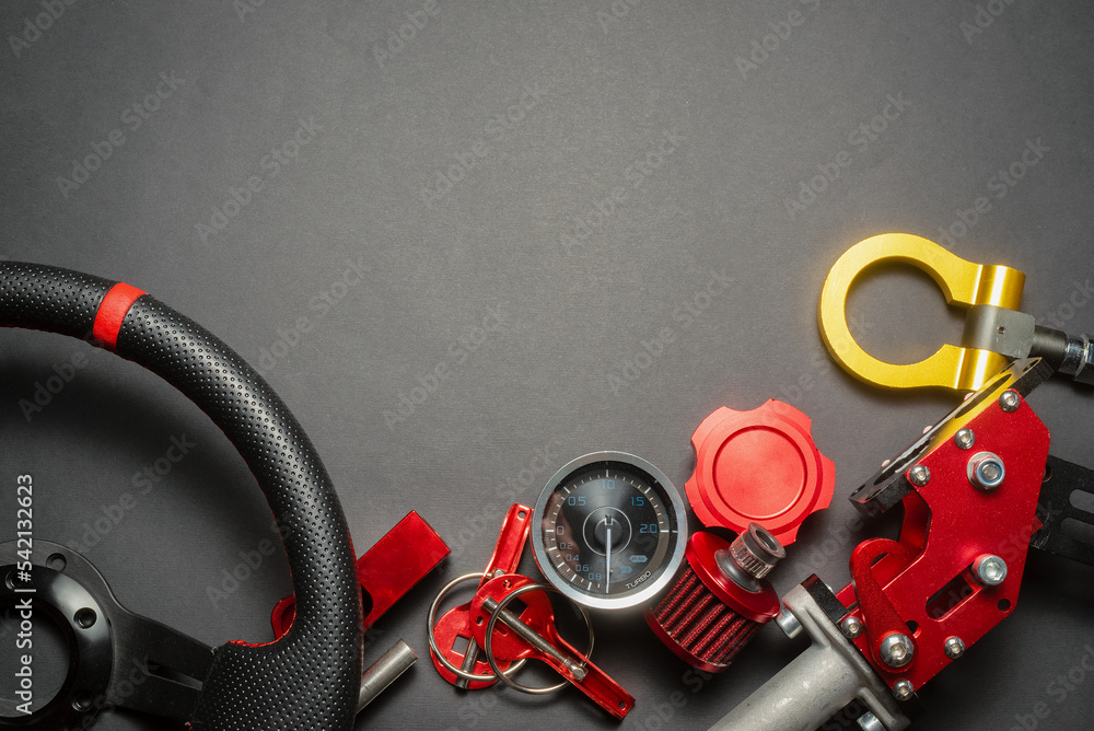 Sport car tuning accessories on the black flat lay background with copy