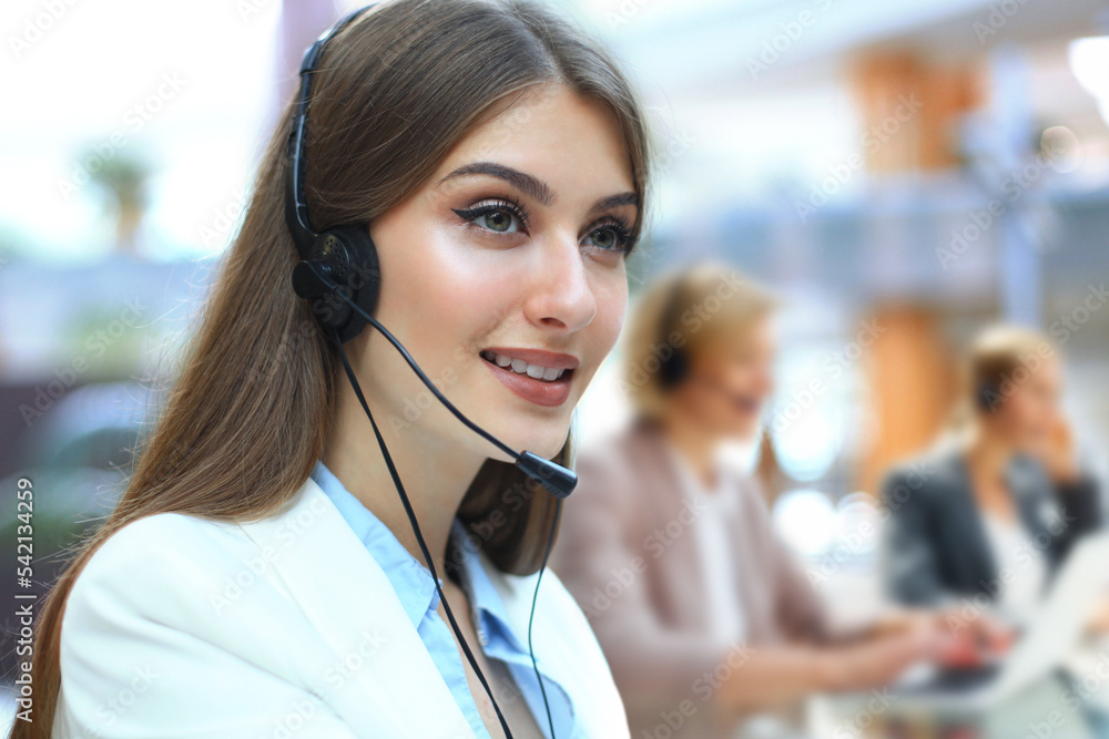 Female customer support operator with headset and smiling. Female customer support operator with headset and smiling.