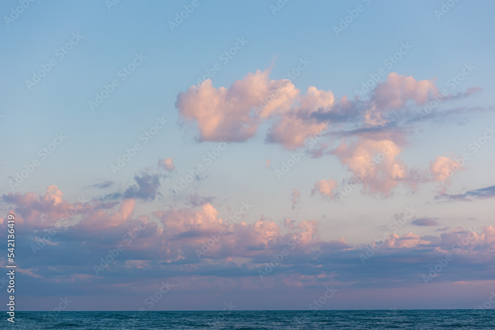 Background with lilac sky with dusk cumulus clouds. Horizon. Heaven with cloudscape with copy space. Concept of freedom and tranquil