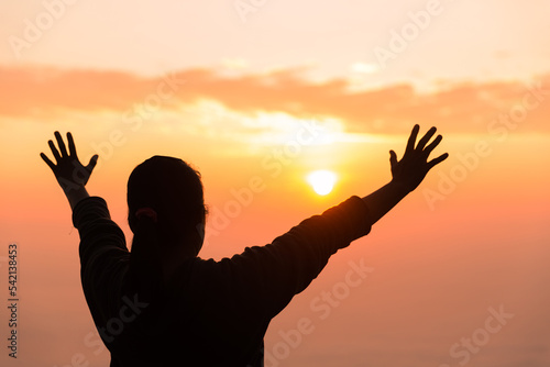 Silhouette of woman hand praying spirituality and religion, female worship to god. Christianity religion concept. Religious people are humble to God. Christians have hope faith and faith in god.